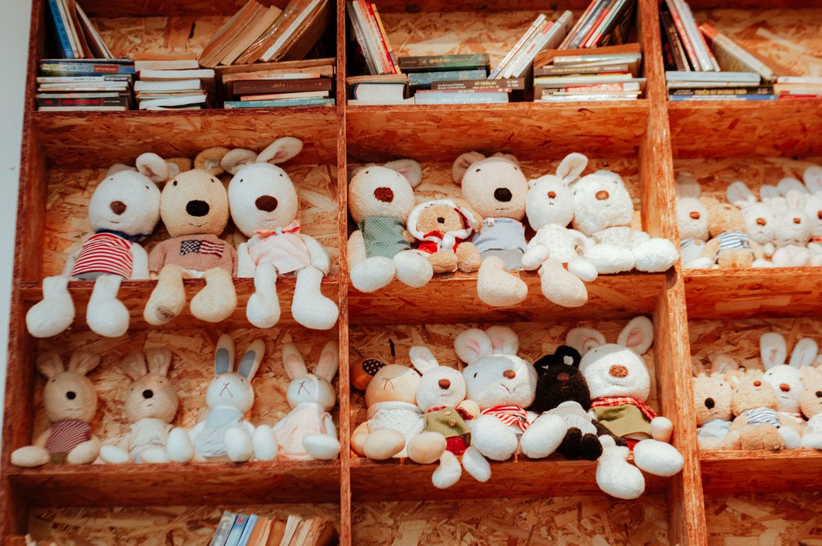 A charming shelf filled with plush animals and books